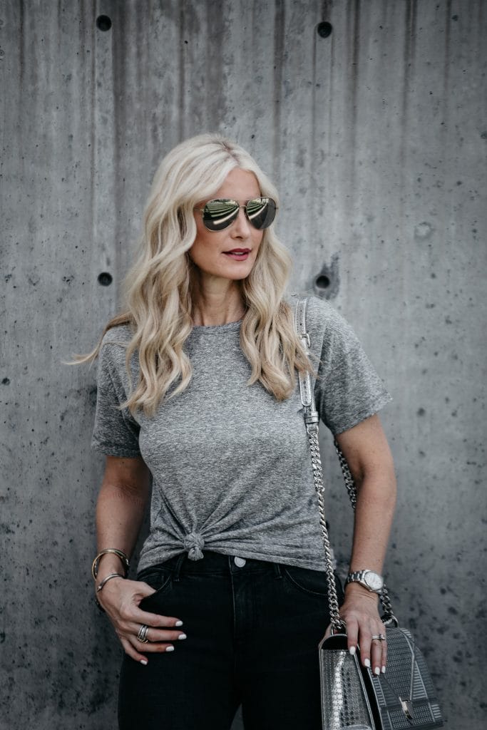Dallas blonde wearing knotted gray tee