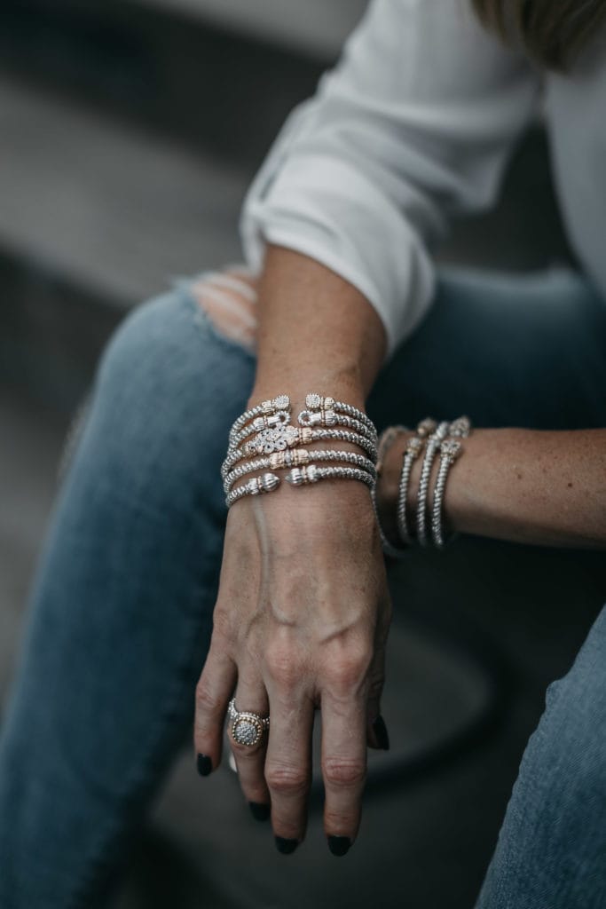 Stacked bracelets and ripped denim