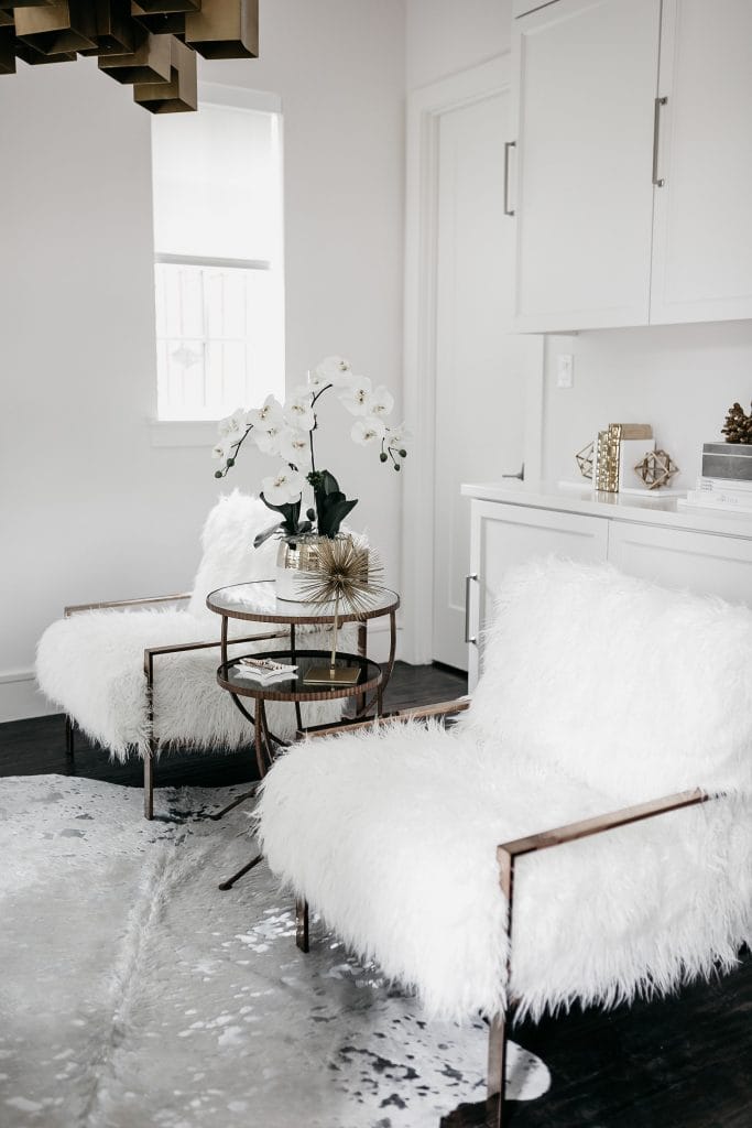 all white blogger office with faux fur chairs