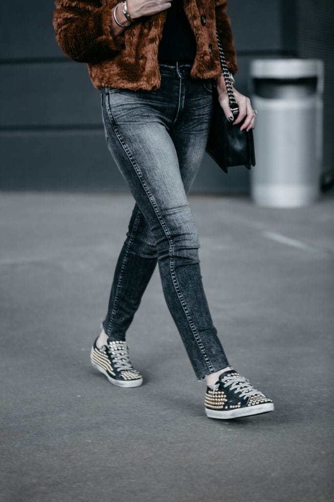 Dallas fashion blogger wearing faux fur jacket, Hudson gray skinny jeans, and Golden Goose Sneakers 