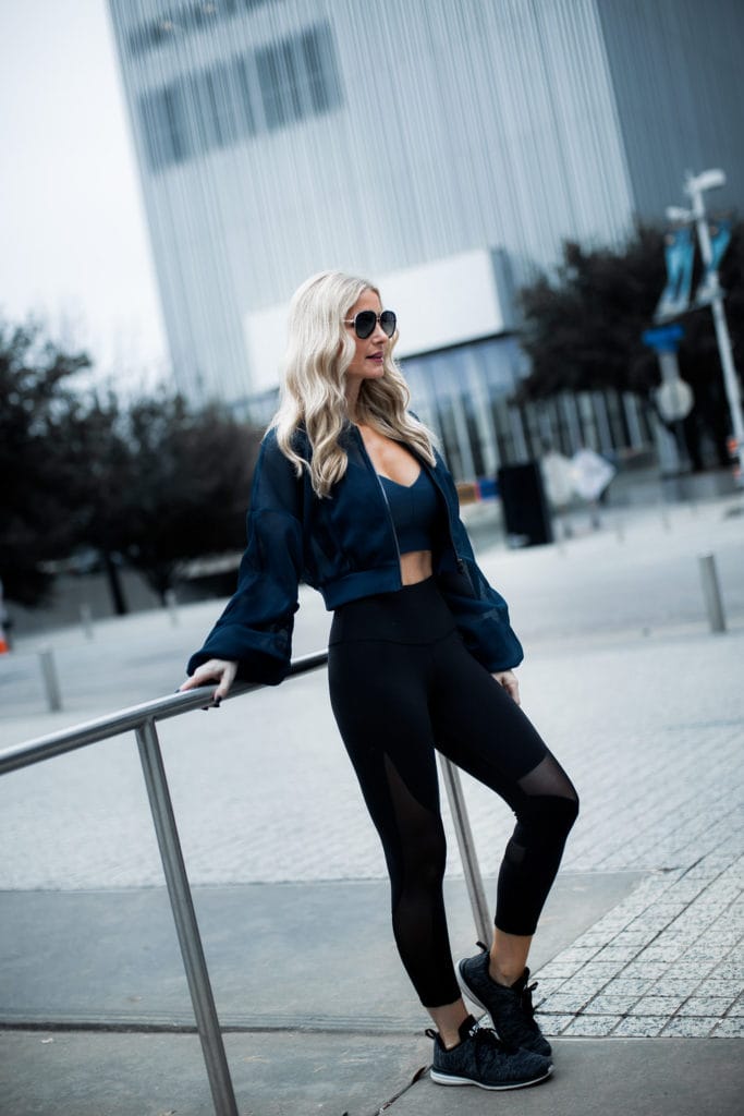 Dallas fashion blogger wearing Alo yoga jacket and leggings
