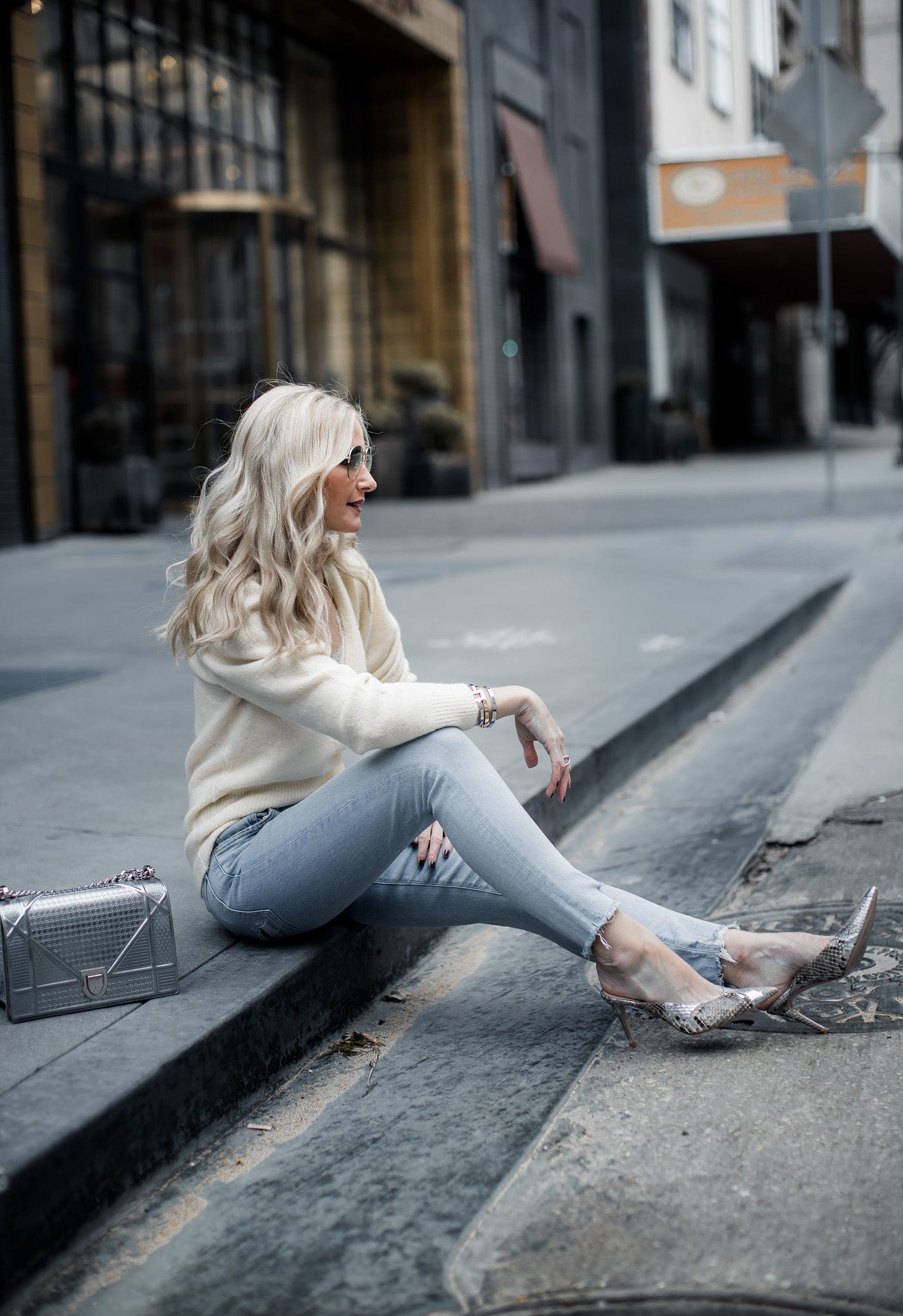 Dallas style blogger wearing Agolde jeans and snake print heels
