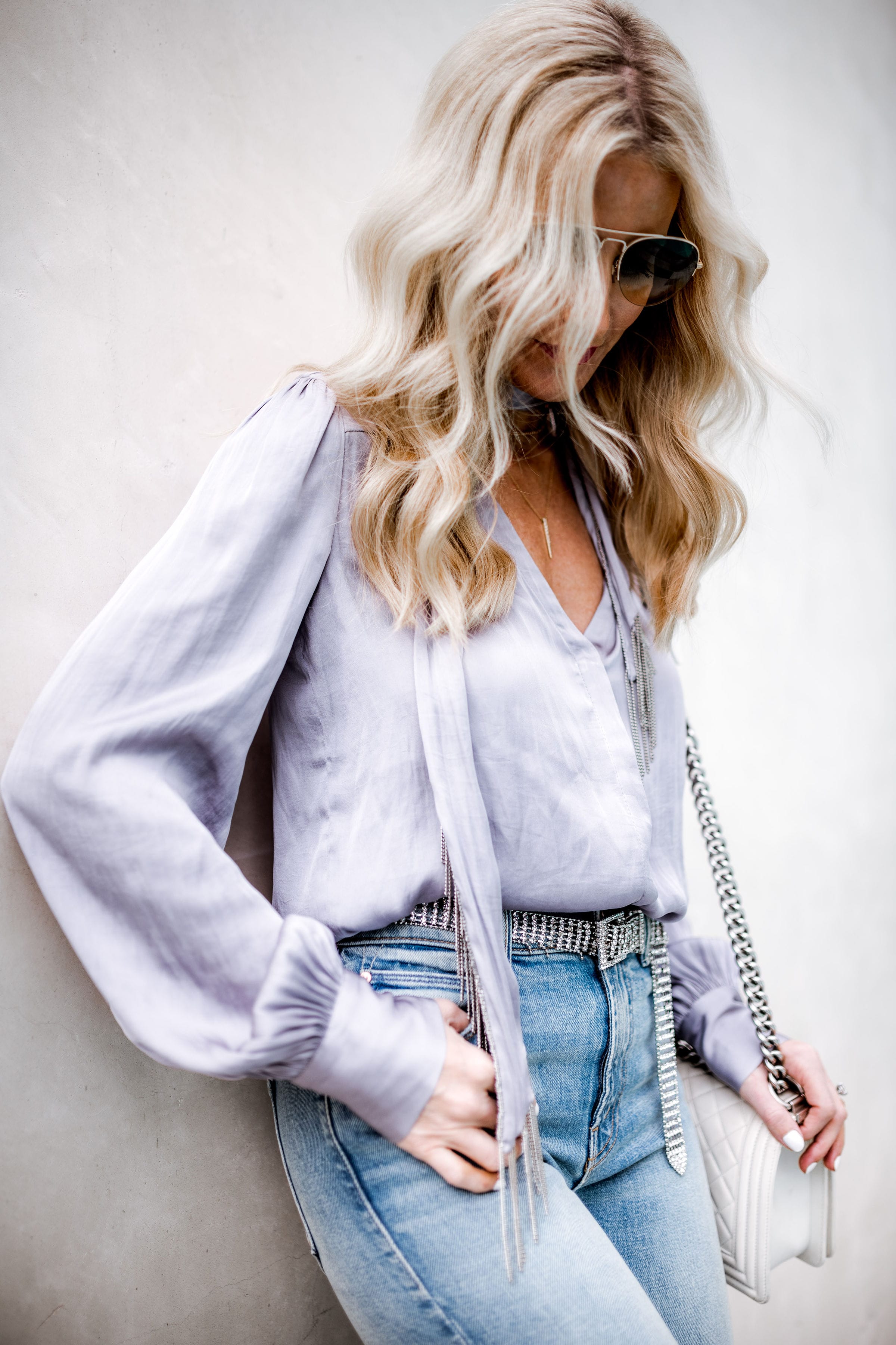 Dallas fashion blogger wearing silver belt and Mother jeans 