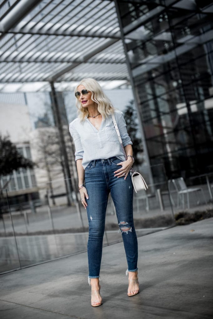 Dallas blogger wearing ripped jeans and nude heels 
