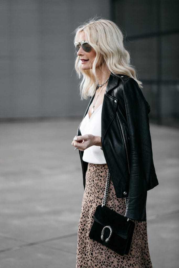 Dallas fashion blogger wearing a black leather jacket and a leopard midi skirt 