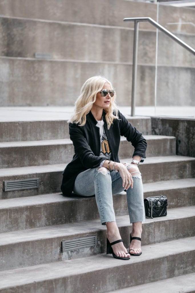 Dallas blogger wearing a black blazer, graphic tee and ripped jeans 
