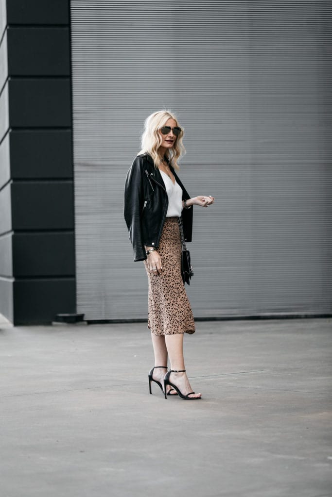 Dallas blogger wearing a leopard midi skirt and a black leather jacket 