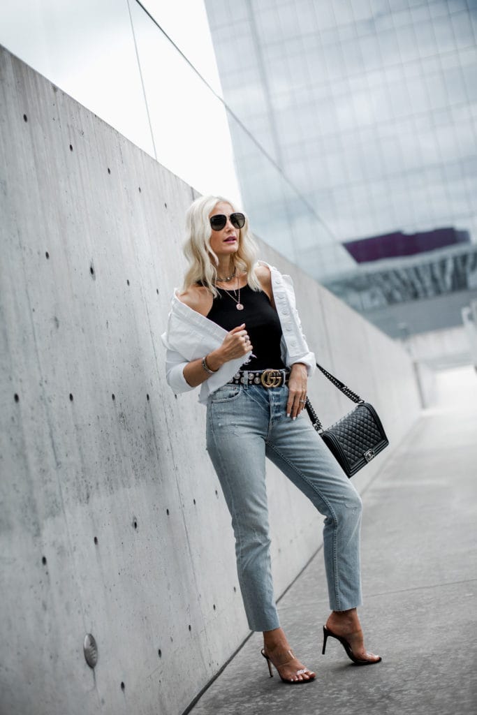 Dallas blogger wearing Gucci belt, white jean jacket, and gold coin necklace 