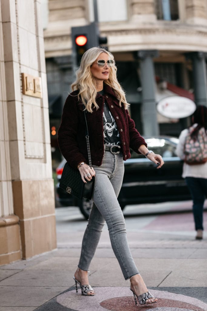 Dallas blonde wearing a faux fur jacket and Agolde jeans