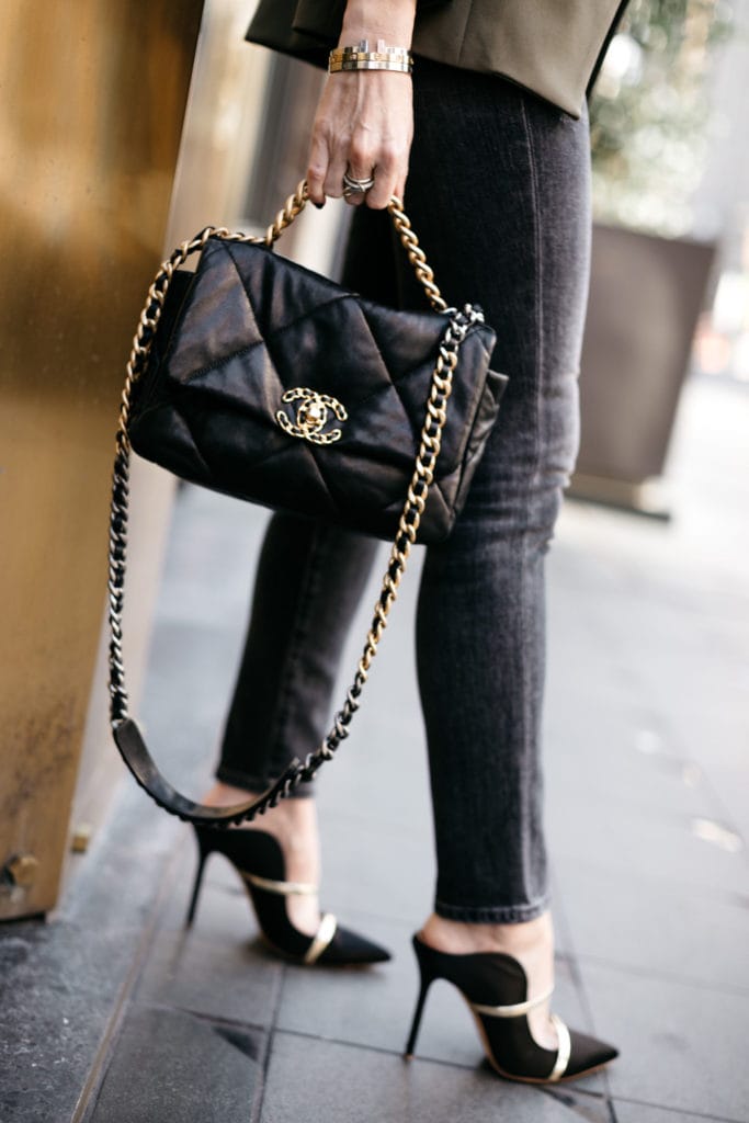 Fashion blogger carrying a black Chanel handbag