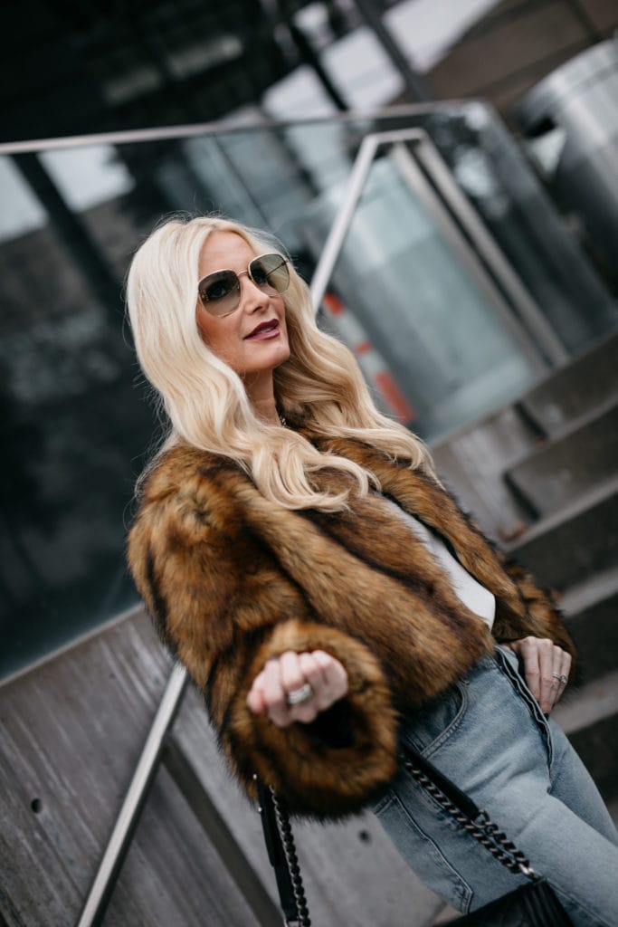Dallas influencer wearing a faux fur jacket and Gucci sunglasses