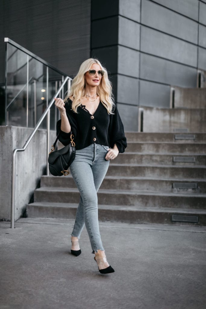 Fashion blogger wearing a black cardigan with jeans