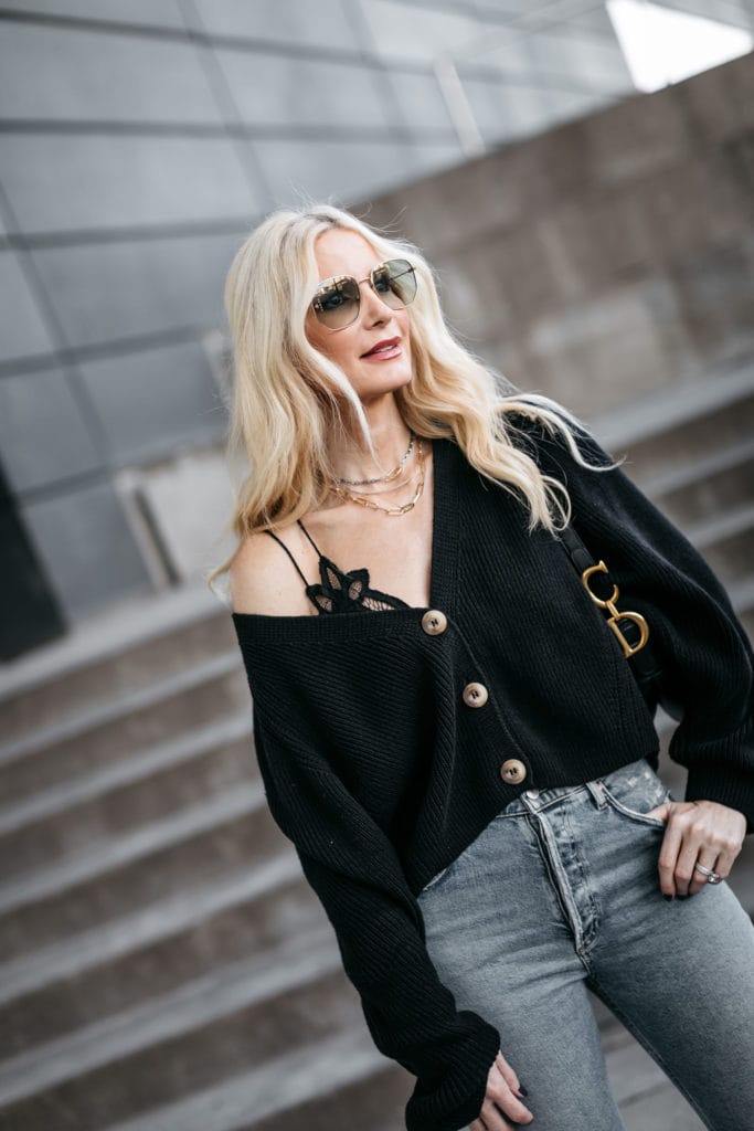 Fashion blogger wearing a black sweater with denim