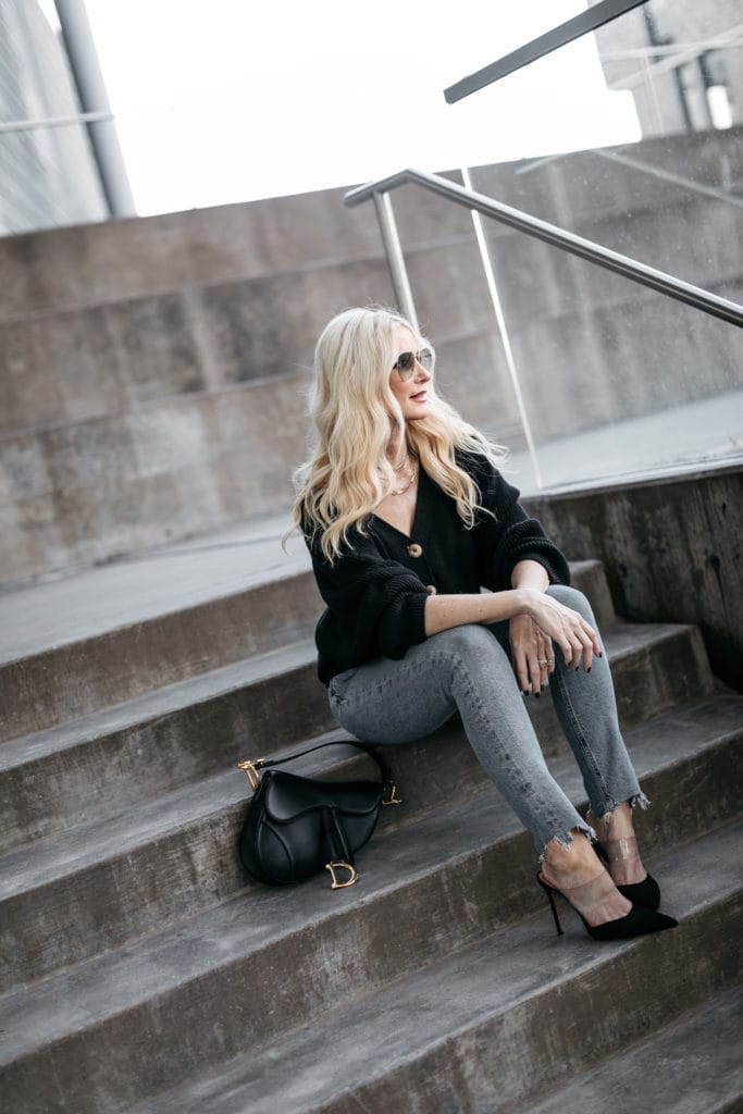 Fashion blogger wearing jeans and a black cardigan