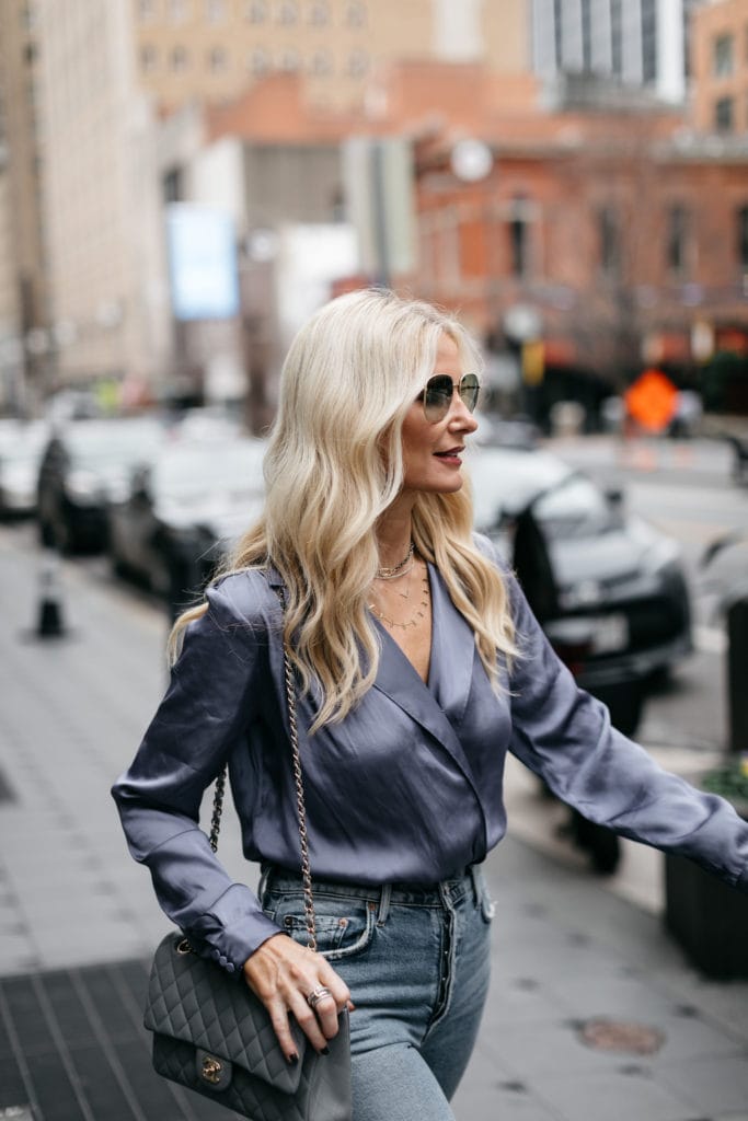 Fashion blogger wearing a blue bodysuit and a Chanel handbag