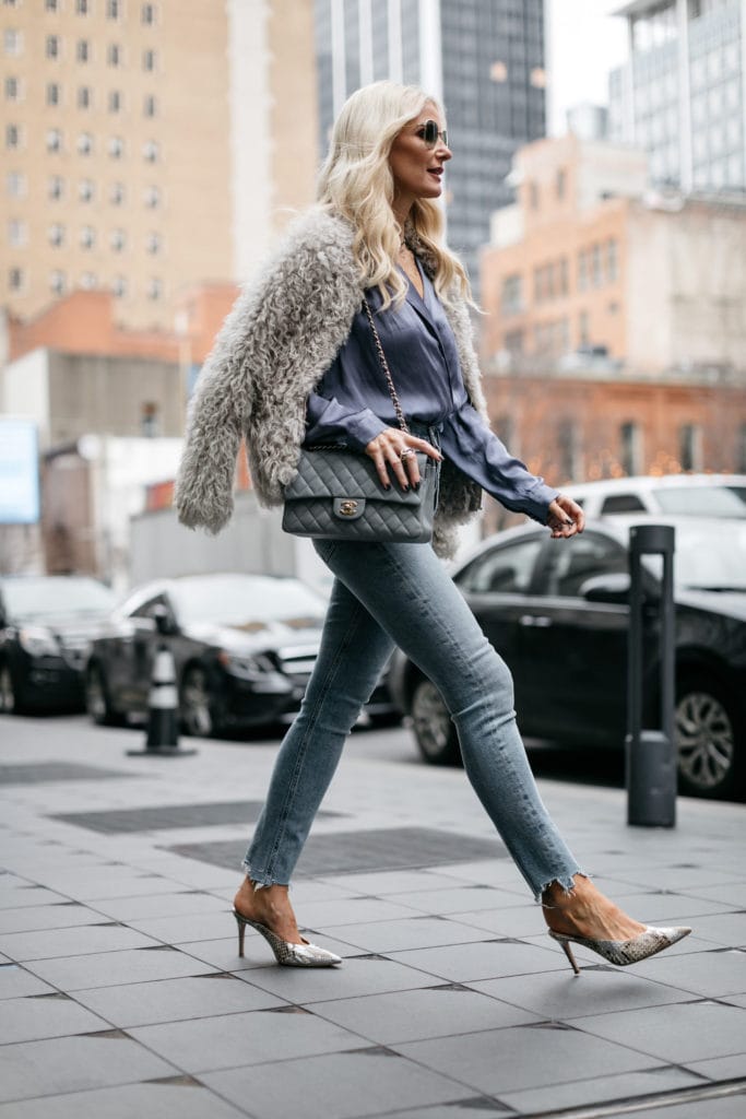 Fashion blogger wearing a fur jacket and snake print heels