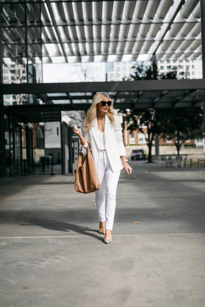 Style blogger wearing a white blazer and white jeans