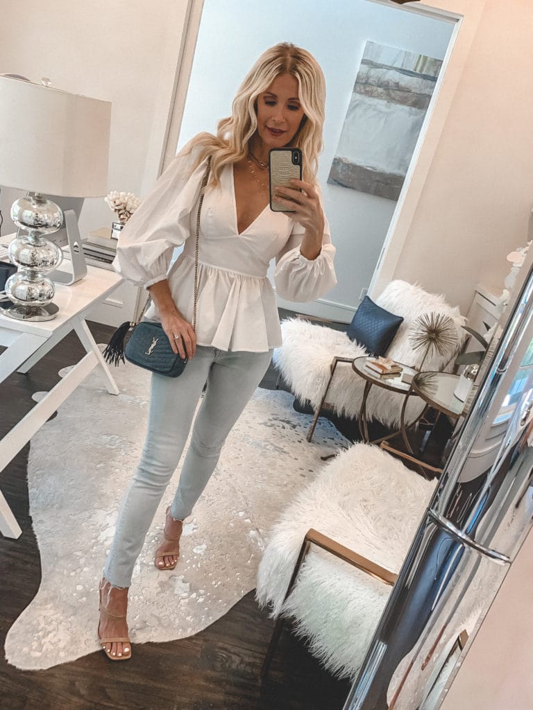 Dallas fashion blogger wearing a balloon sleeve white top and light wash denim for spring and summer