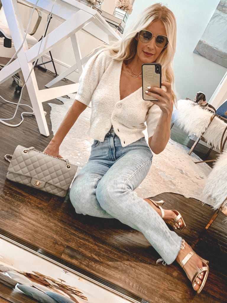 Dallas blogger wearing a white sweater and denim