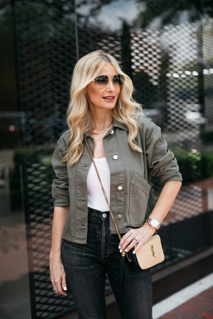 Dallas blogger wearing an army green jacket and black denim