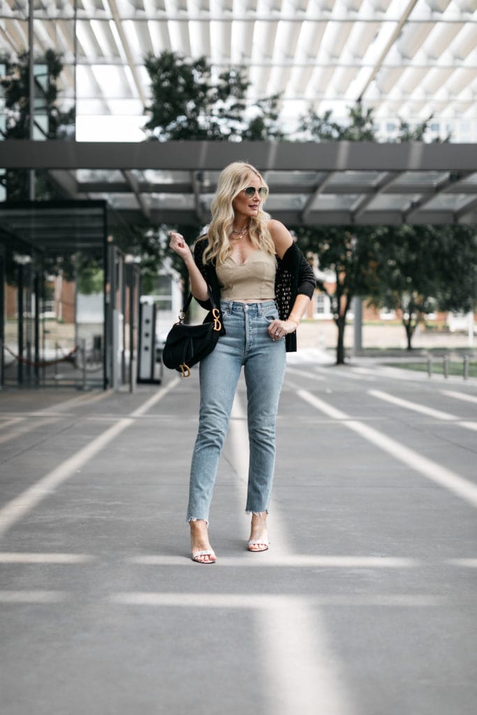 Dallas style blogger wearing Agolde light wash denim and a summer crop top