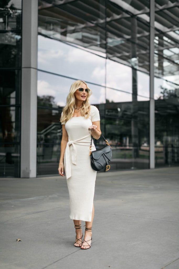 Dallas blogger wearing a white midi dress with black heels