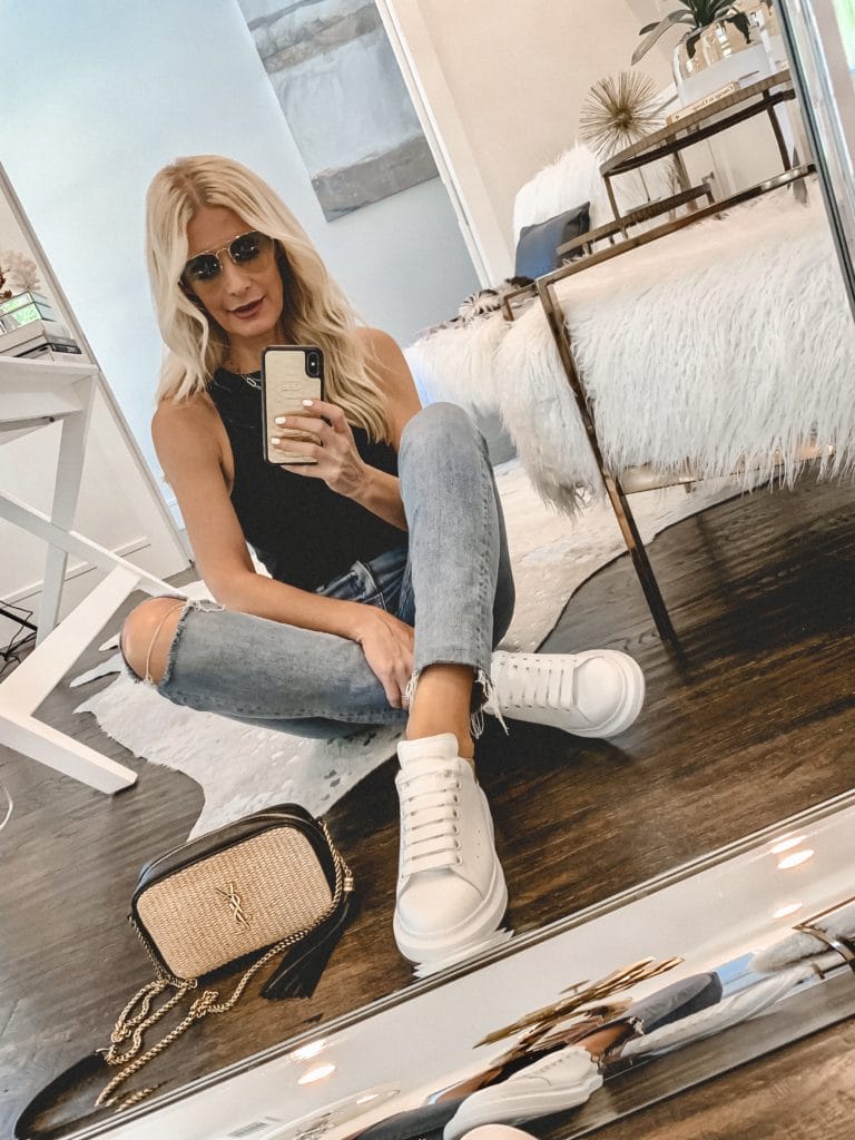 Dallas blogger wearing a black tank bodysuit and white sneakers 