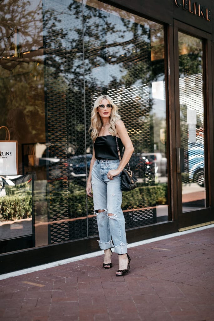 Fashion influencer wearing a black strapless top and Moussy jeans