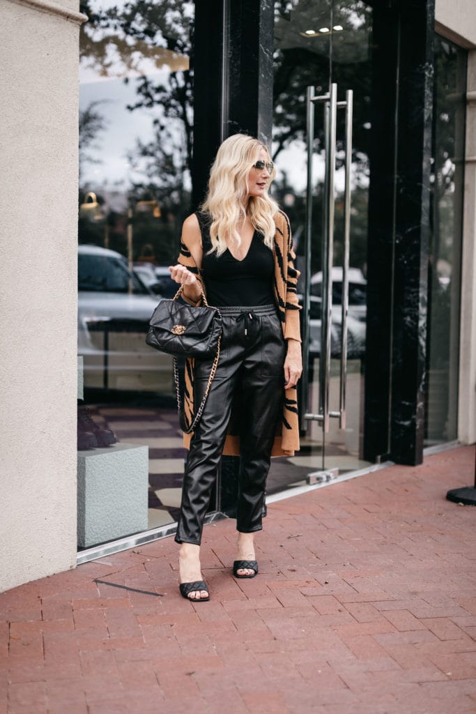 Dallas blogger wearing a rust zebra cardigan and black leather joggers for fall