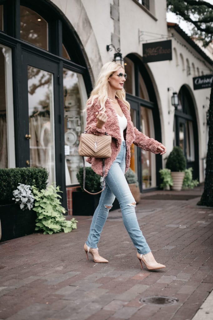 Dallas fashion blogger wearing a blush faux fur jacket and high waisted jeans