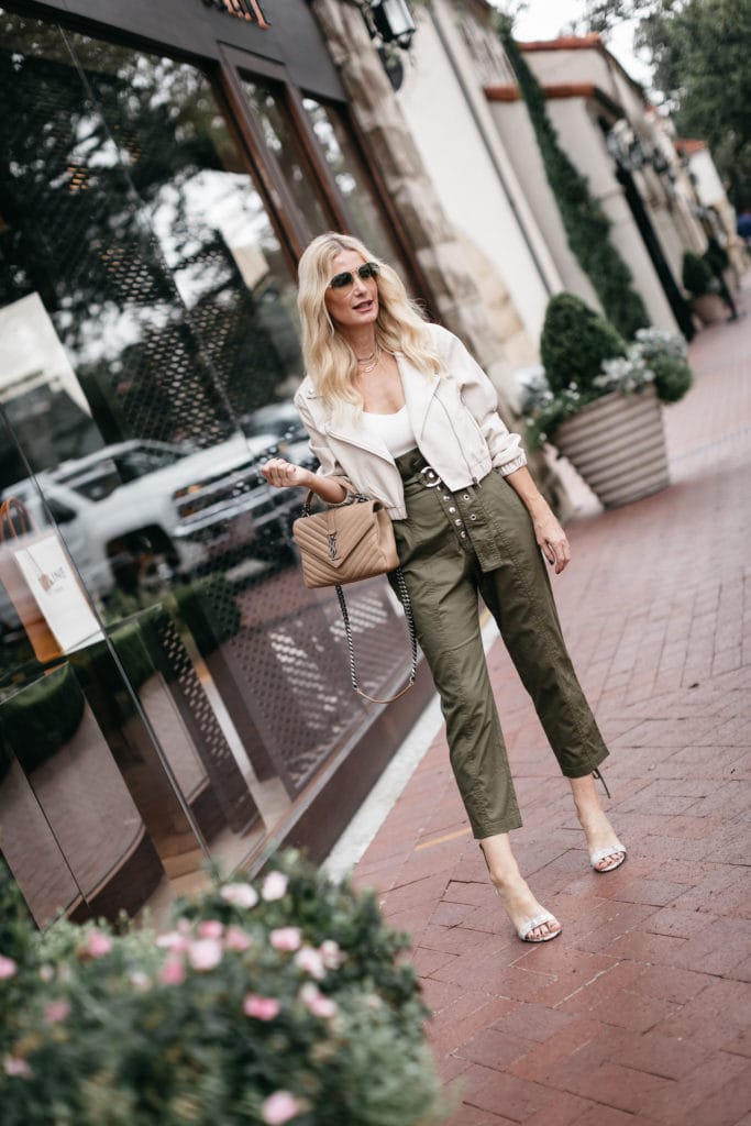 Dallas style blogger wearing paper bag pants and a white leather Moto jacket