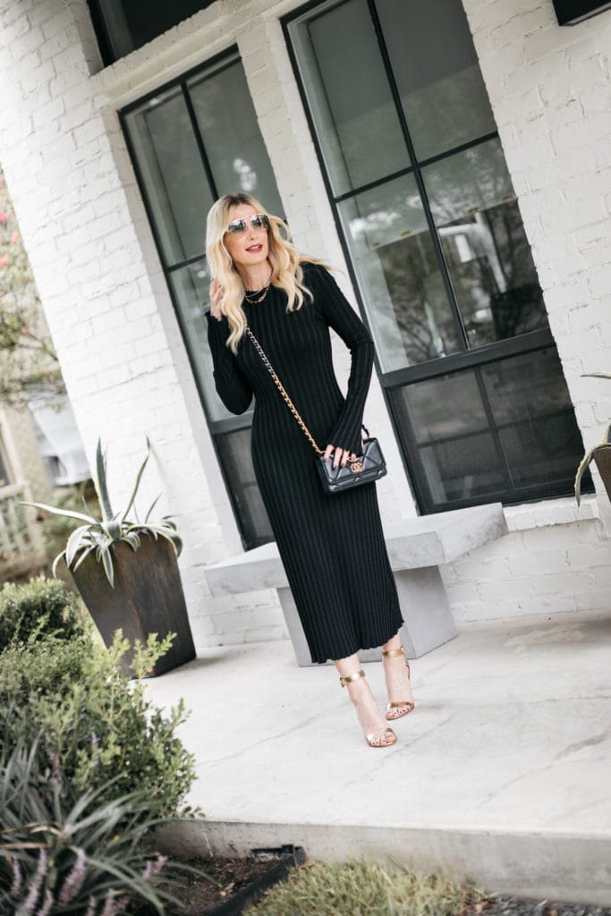 Dallas fashion blogger wearing a black ribbed midi dress and gold heels
