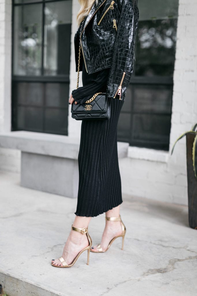 Dallas blogger wearing a black Moto jacket and a black dress with gold heels for fall