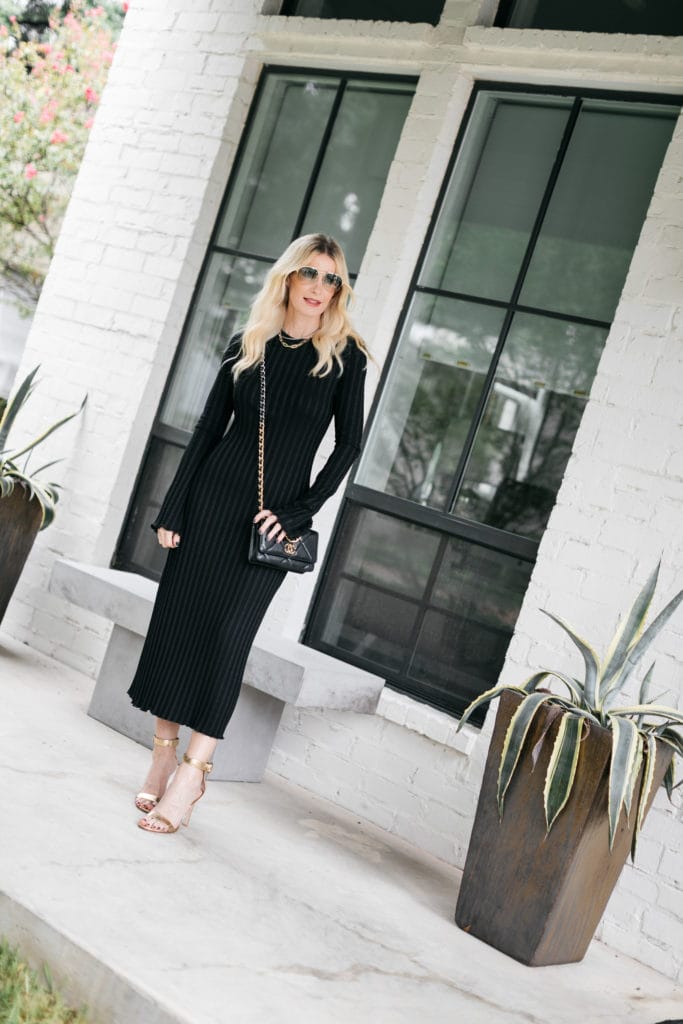 Fashion blogger wearing a long-sleeve black dress and gold heels for fall and winter