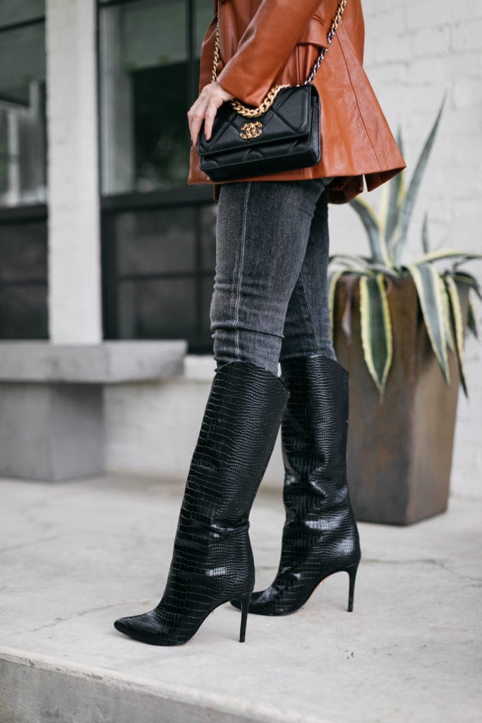 Fashion blogger wearing black knee-high boots and a Chanel handbag