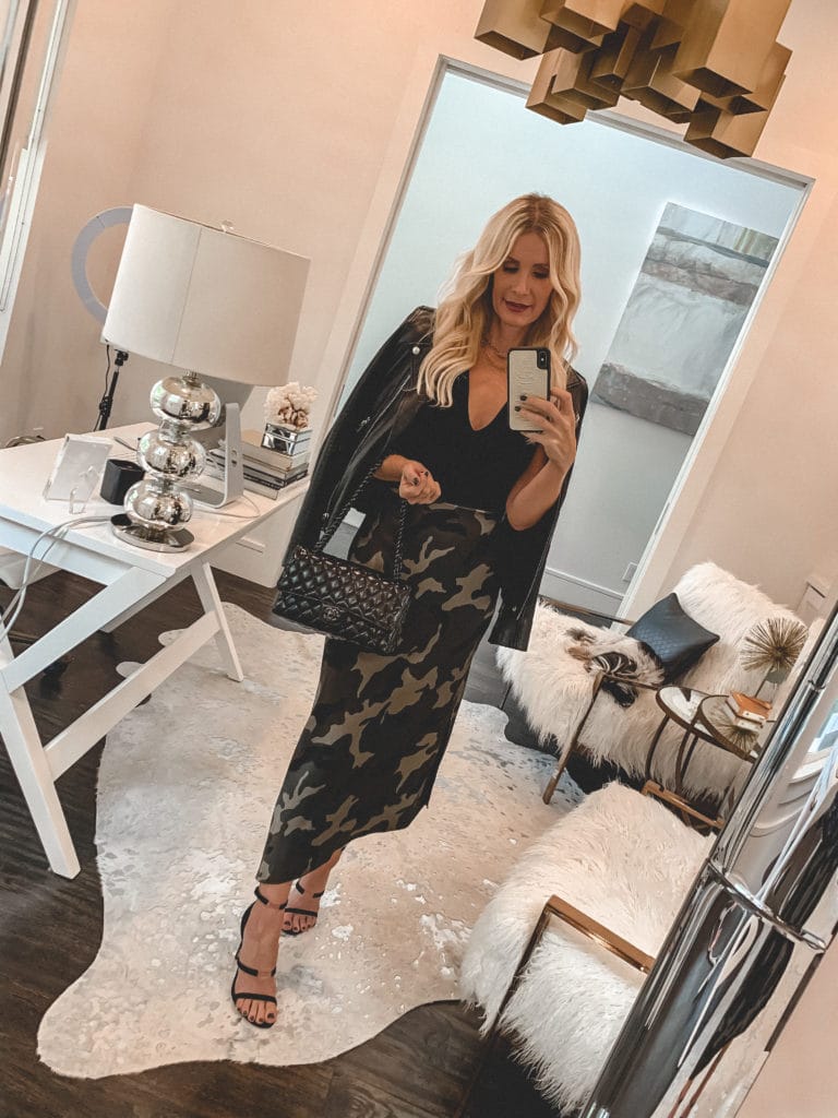 Dallas blogger wearing a black bodysuit and a camo skirt