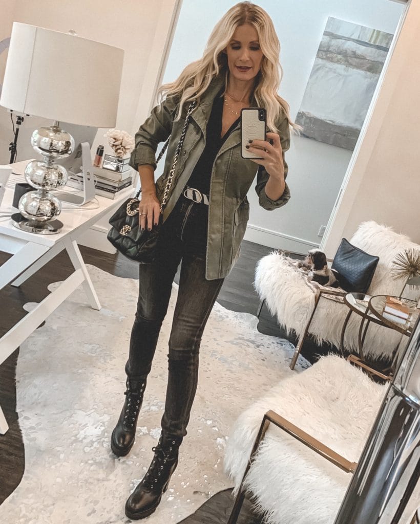 Dallas blogger wearing an army green jacket and faded black denim