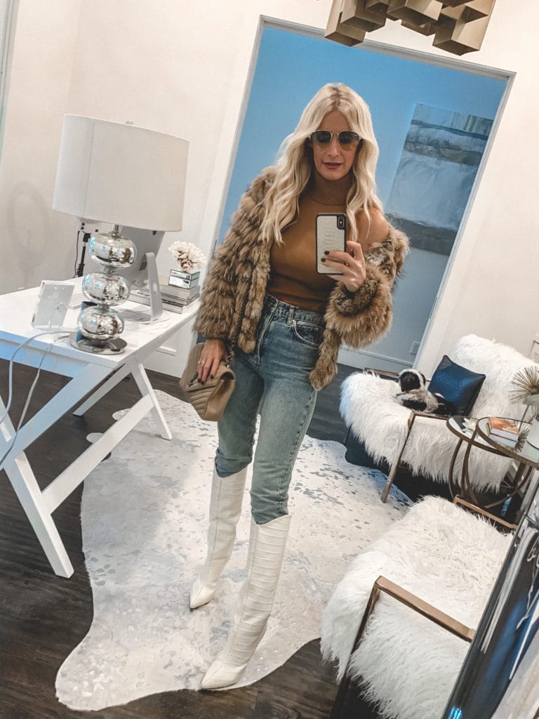 Dallas fashion blogger wearing a faux fur jacket and white knee high boots