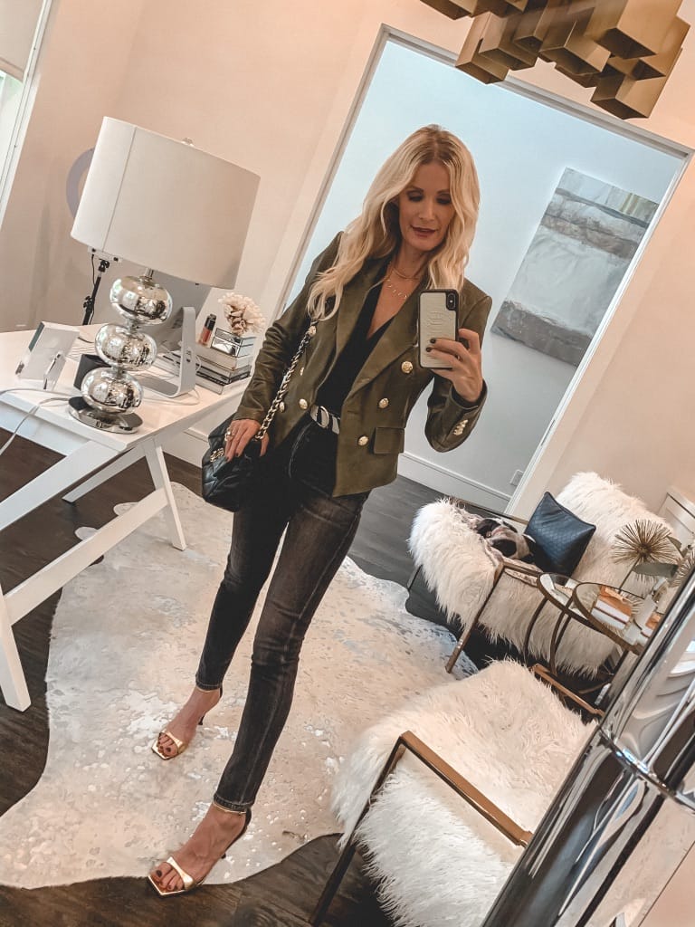 Dallas blogger wearing black denim and an army green jacket with gold hardware