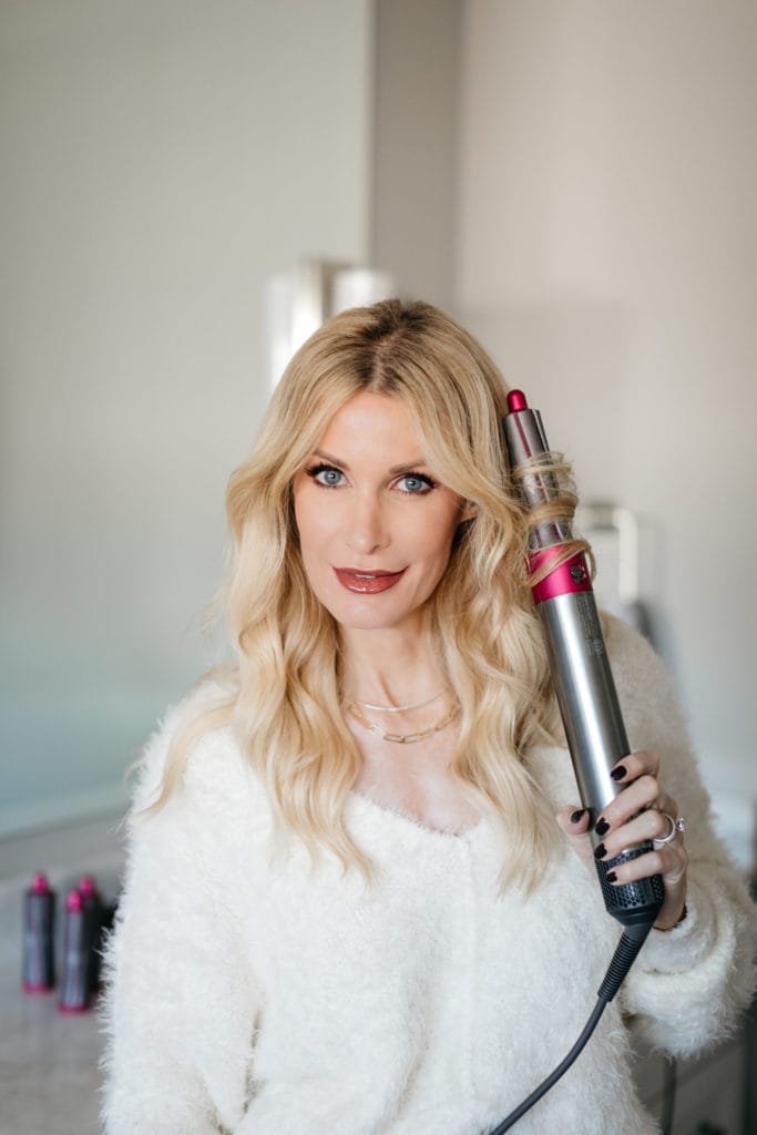 Style blogger wearing a cozy chic white sweater and curling iron by Dyson