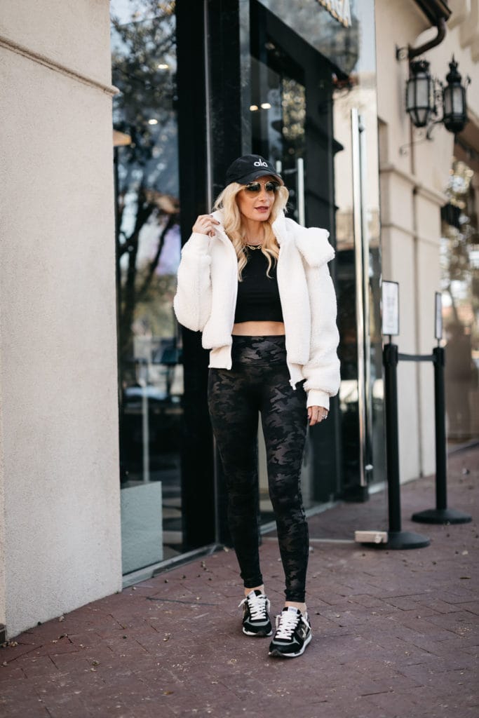 Dallas blogger wearing a faux fur jacket and workout wear
