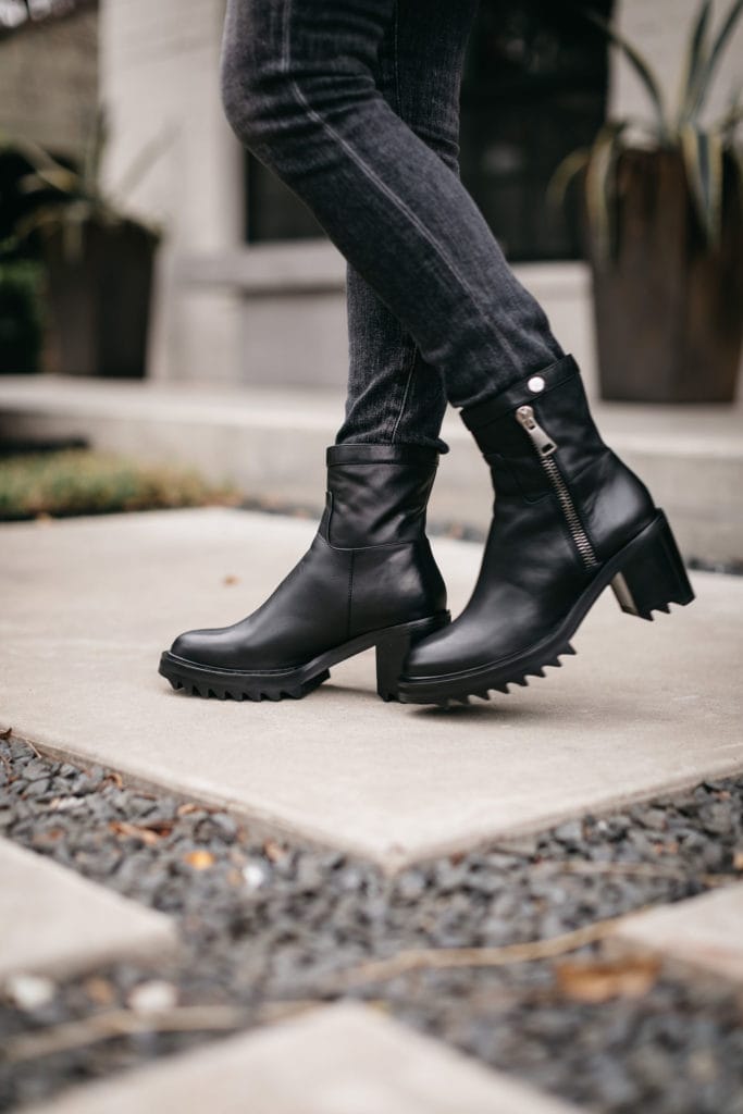 Dallas fashion influencer wearing black combat boots and black faded jeans