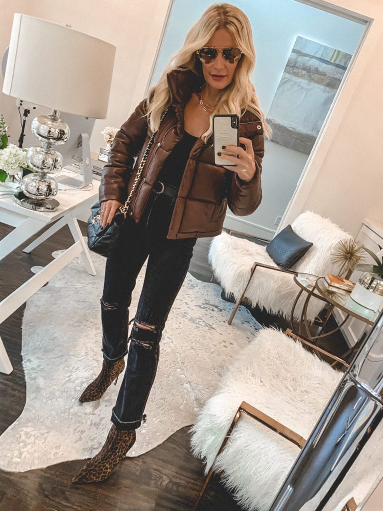 Dallas blogger wearing a brown puffer jacket and dark wash denim for fall and winter