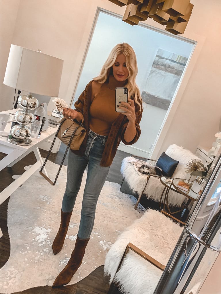 Style blogger wearing a rust brown cardigan with light wash denim and brown booties