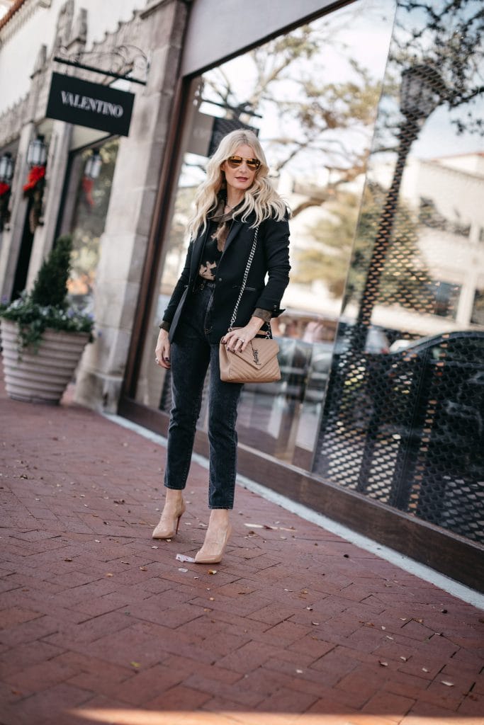 Style blogger wearing a black blazer and beige heels