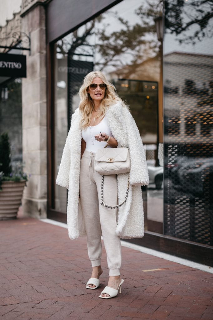Fashion blogger wearing a white teddy coat and oatmeal colored joggers