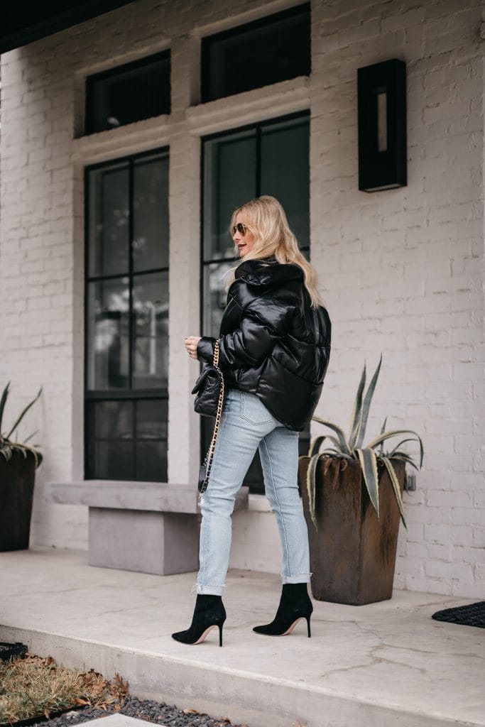 Dallas blogger wearing light wash denim and a black puffer jacket for winter 