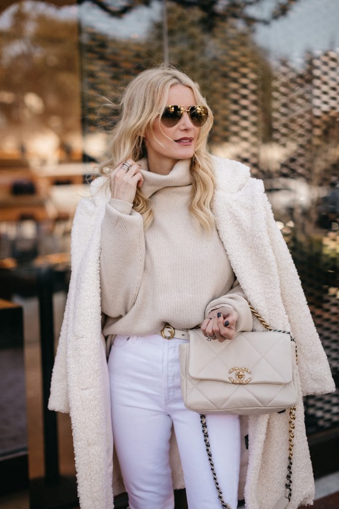 Fashion and style blogger wearing a neutral winter look and a white Chanel bag