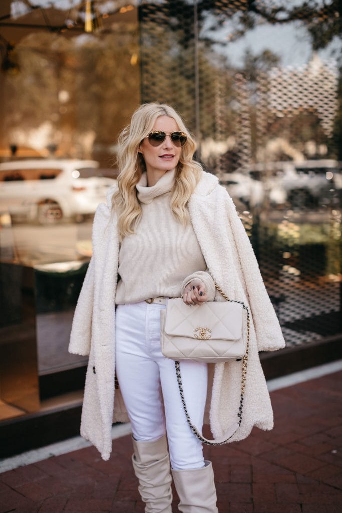 Dallas blogger wearing a cream colored cashmere sweater and a white teddy coat