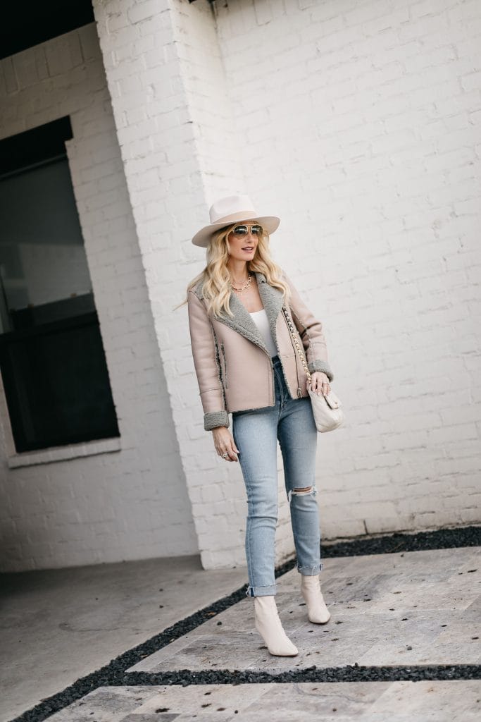 Dallas blogger wearing a warm jacket and a hat part of the curateur box